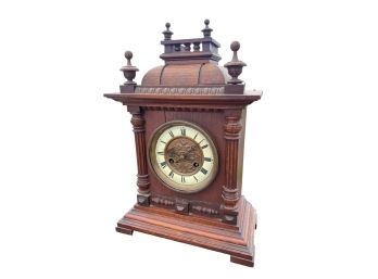 OAK MANTEL CLOCK w/ RELIEF DECORATED BRASS DIAL